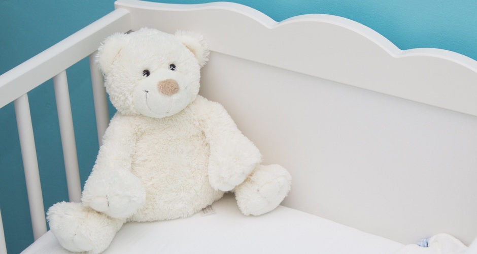 Teddy bear in crib